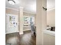 Bright entryway featuring wood floors and a view into the dining area at 6048 Prodigy Ln, Locust Grove, GA 30248