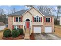 Inviting front exterior of a two-story home with a red front door, brick accents, and a well-maintained lawn at 2275 Perch Sw Way, Marietta, GA 30008