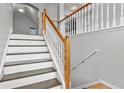 Well-lit staircase with white banisters, leading to the upper level of the home at 2275 Perch Sw Way, Marietta, GA 30008