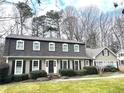 Beautiful two-story home with a well-maintained lawn, complemented by mature trees at 1903 Olde Village Run, Dunwoody, GA 30338
