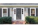 Close-up of a front entrance with black door, sidelights, and charming house number at 1903 Olde Village Run, Dunwoody, GA 30338