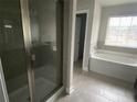 Primary bathroom featuring a shower with glass door, soaking tub, and dark wood vanity at 5021 Falcon Pt, Douglasville, GA 30135