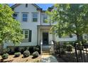 Inviting two-story townhome with manicured landscaping and a secure black fence at 353 Vista Ln, Woodstock, GA 30189