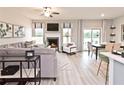 Open-concept living room with fireplace, modern furniture, and sliding glass doors leading to outdoor space at 367 Denali Butte Ter, Canton, GA 30114