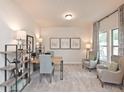Well-lit study with neutral tones, large window, stylish decor, and plush carpeting at 367 Denali Butte Ter, Canton, GA 30114