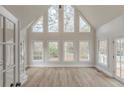 Bright, airy living room with many windows, hardwood floors, and high ceilings at 2541 Berwick Walk, Snellville, GA 30078