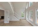 Bright living room featuring high ceilings, many windows, hardwood floors, and a staircase at 2541 Berwick Walk, Snellville, GA 30078