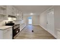 Well-lit kitchen features white cabinetry, modern appliances, and a functional layout for cooking at 250 Southmoor Cir, Stockbridge, GA 30281
