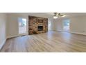 Bright and airy living room with a stone fireplace, updated flooring, and ample natural light at 250 Southmoor Cir, Stockbridge, GA 30281