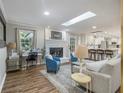 Cozy living room featuring hardwood floors, a brick fireplace, skylight and open floor plan at 2810 Dunnington Cir Cir, Atlanta, GA 30341