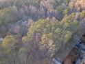 Aerial view of a tree-filled property with a survey map overlay at 2057 Sugar Pike Rd, Woodstock, GA 30188