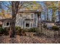 Exterior view of home with wood siding and lush surrounding trees at 2057 Sugar Pike Rd, Woodstock, GA 30188