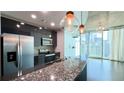 Modern kitchen features stainless steel appliances, granite counters and industrial pendant lighting at 400 W Peachtree Nw St # 2808, Atlanta, GA 30308