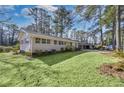 Spacious front lawn of this charming home, surrounded by mature trees, giving curb appeal and charm at 1963 Shepherd Sw Cir, Atlanta, GA 30311
