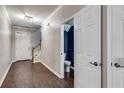 Entryway with hardwood floors, coat closet, and view of staircase and powder room at 3349 Thornbridge Dr, Powder Springs, GA 30127