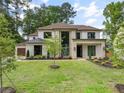 Beautiful front exterior view highlighting manicured lawn, modern architectural details, and oversized garage at 401 Lynne Cir, Alpharetta, GA 30009