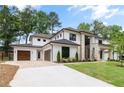 View of driveway leading to the attached garage and the front facade of the home at 401 Lynne Cir, Alpharetta, GA 30009