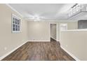 Inviting living room with wood-look flooring, neutral walls, and modern lighting fixture at 1729 James Burgess Rd, Suwanee, GA 30024
