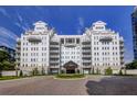 A luxurious condominium building featuring a porte cochere, circular driveway, and manicured landscaping at 2500 Peachtree Nw Rd # 606N, Atlanta, GA 30305