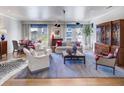 A traditionally styled living room with hardwood floors, a blue rug and access to the dining area at 2500 Peachtree Nw Rd # 606N, Atlanta, GA 30305