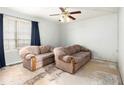 Bright living room with a ceiling fan and large window at 2613 Stratford Ln, Morrow, GA 30260