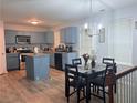 Open kitchen and dining area featuring modern appliances and a functional center island at 204 Hightower Trl, Riverdale, GA 30274