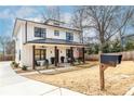 Beautiful two-story home featuring a stylish modern farmhouse design with a welcoming front porch at 1751 Stanwood Se Ave, Atlanta, GA 30317