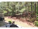 Back patio featuring outdoor seating nestled against a backdrop of lush greenery and mature trees at 5433 Cascade Sw Rdg, Atlanta, GA 30336