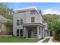 Beautifully designed home featuring modern architecture, a cozy porch, and lovely landscaping at 1186A Francis Nw St, Atlanta, GA 30318