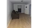 Living room with vinyl flooring and a brown sofa at 2305 Phillips Rd, Lithonia, GA 30058