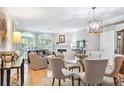 Elegant living and dining area with hardwood floors, fireplace, and stylish chandelier at 5306 Brooke Ridge Dr, Atlanta, GA 30338