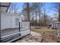 Back porch featuring a trampoline, backyard, and wooden porch at 545 Birch Ln, Lawrenceville, GA 30044