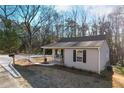 Street view of a well-maintained home with a covered porch and manicured lawn at 100 Reed St, Canton, GA 30114