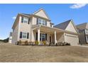 Charming two-story home with an attached garage and covered front porch with seating at 250 Riverclub Rd, Acworth, GA 30101