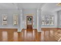 Bright foyer with hardwood floors, white walls, and natural light at 4050 Preserve Crossing Ln, Cumming, GA 30040
