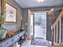 Inviting entryway featuring tile flooring, grey wall paint, and an open front door at 2426 Glenbonnie Dr, Atlanta, GA 30360