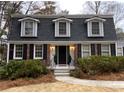 Charming two-story home with brick and vinyl siding, shutters, and front yard landscaping at 2426 Glenbonnie Dr, Atlanta, GA 30360