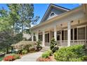 Charming home with stone steps and a landscaped front yard leading to covered porch at 306 Blake Dr, Canton, GA 30114