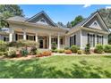 Charming home with a landscaped front yard and inviting covered porch with columns at 306 Blake Dr, Canton, GA 30114