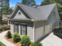 Spacious three-car garage with an upstairs and lush landscaped yard at 306 Blake Dr, Canton, GA 30114