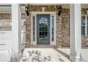 Close-up of a stylish gray front door with decorative glass and sidelights at 920 Sublime Trl, Canton, GA 30114