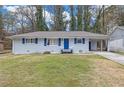 Charming single-story home with blue shutters and door, manicured front lawn at 470 Oriole Dr, Marietta, GA 30067