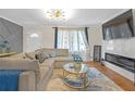 Cozy living room with a large sectional, stylish coffee table and electric fireplace at 470 Oriole Dr, Marietta, GA 30067
