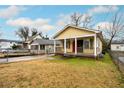 Quaint yellow home with a cozy front porch and a spacious front yard at 718 Dalvigney Nw St, Atlanta, GA 30318