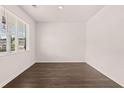 Bright, airy bedroom with modern wood-look flooring and a large window letting in natural light at 290 Halibut Cir, Covington, GA 30016