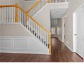 Bright foyer features a staircase with wooden railing and new hardwood flooring at 3565 Mystic Dr, Buford, GA 30519