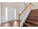 Inviting foyer with staircase and new wood floors, flanked by sidelights at 3565 Mystic Dr, Buford, GA 30519
