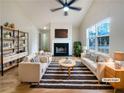 Bright living room with a fireplace, large window, and modern decor at 17 Cedars Glen Pl, Villa Rica, GA 30180