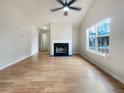 Spacious living room featuring a fireplace, large window and hardwood floors at 17 Cedars Glen Pl, Villa Rica, GA 30180
