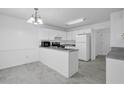 Bright eat-in kitchen with white cabinets, gray countertops, and tile flooring at 2612 Kirkhill Ct, Lawrenceville, GA 30044